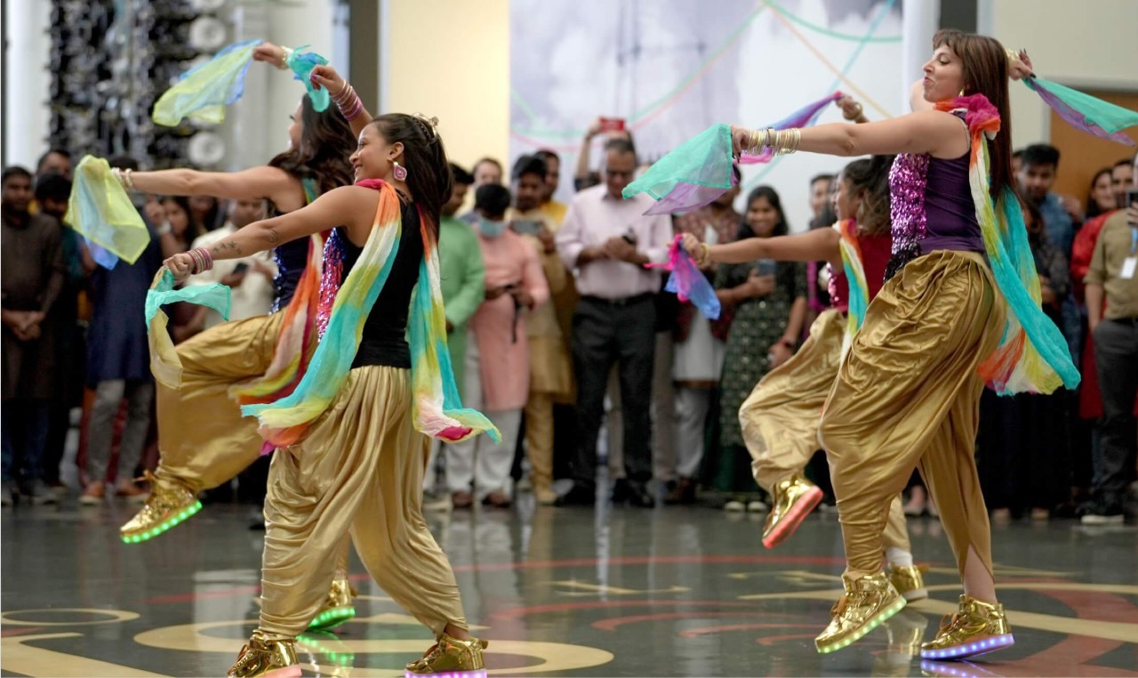 Traditional dancers celebrating Diwali for a fun workplace culture event at DISH