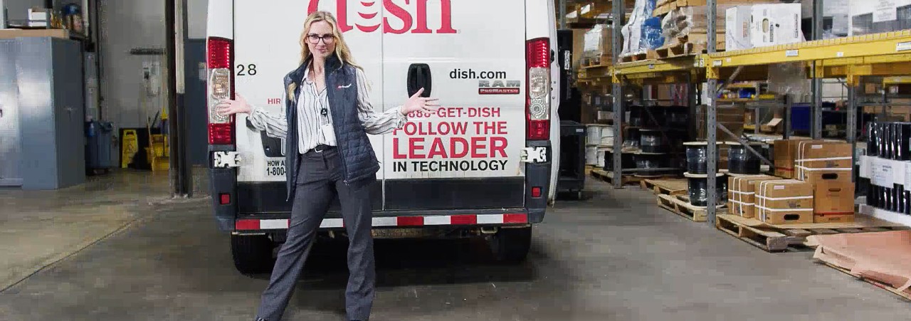 Molly Cook, a leader of our frontline technician teams, poses next to a DISH van.