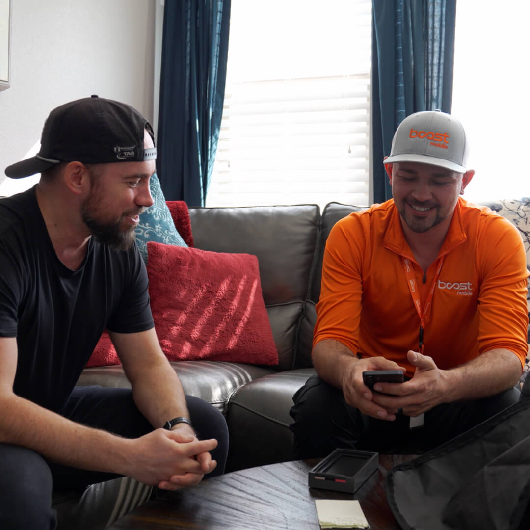 An image of technicians supporting customers with Boost Mobile products - Image 1