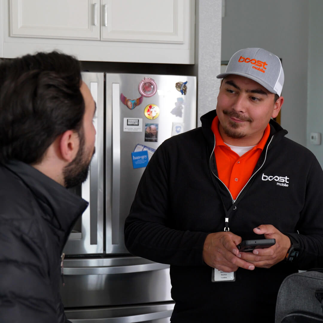 An image of technicians supporting customers with Boost Mobile products - Image 3