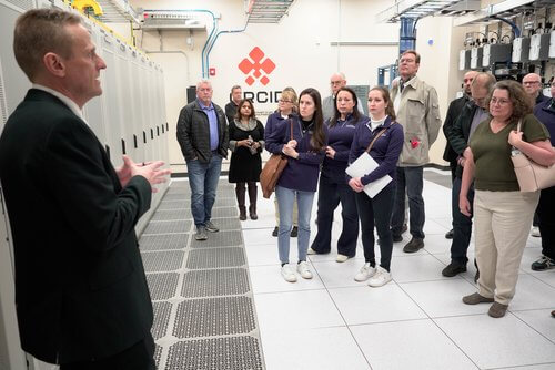 An image of team members celebrating the opening of EchoStar’s Open RAN Center for Integration & Deployment (ORCID).