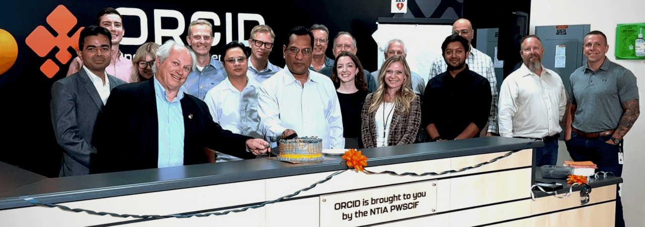 An image of team members celebrating the opening of EchoStar’s Open RAN Center for Integration & Deployment (ORCID).